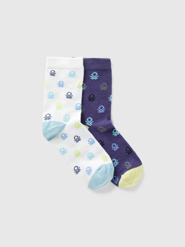 Two pairs of socks with blue and white logos Junior Boy